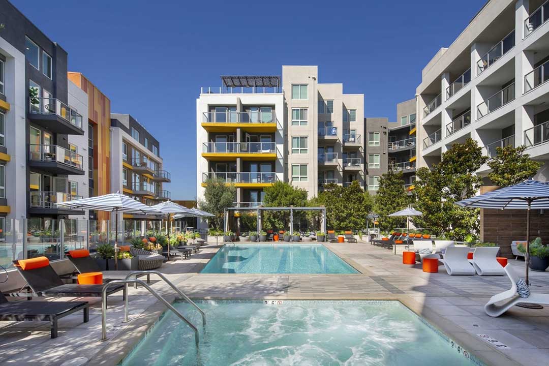 Commercial multifamily pool with integrated spa, deck circulation, and controlled public-use access